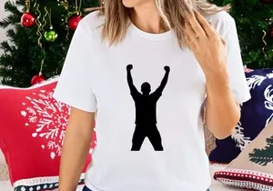A person celebrating with arms raised in triumph and fists clenched in victory