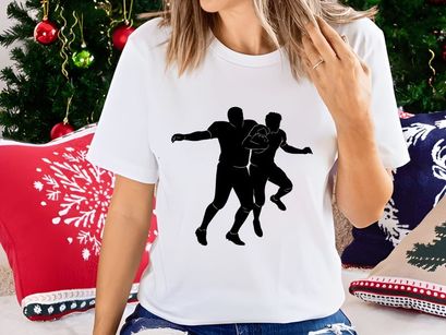 Two american football players in action one holding the ball