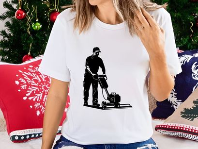 A man operating a plate compactor on a construction site with safety gear