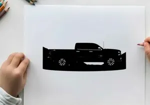 Silhouette of a pickup truck against a mountain range silhouette