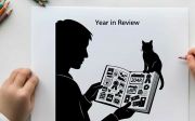 Silhouette of a person reading a newspaper with a cat on their lap