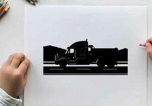 Silhouette of a large truck driving on a road with mountains