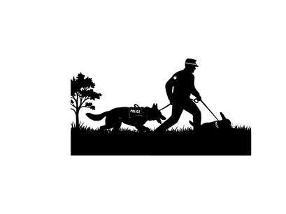 Police officer and dog in silhouette searching for evidence