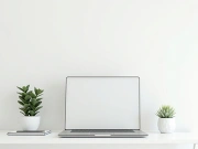 Minimal desk workspace with laptop, notebook, and indoor plant