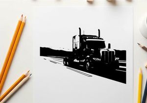 Silhouette of a semi truck driving on a highway with mountains