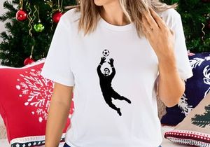 Soccer goalkeeper in action catching a ball