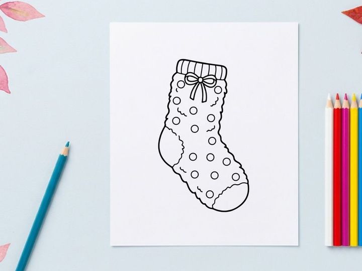 Christmas stocking line art drawing with polka dot pattern and decorative bow icon