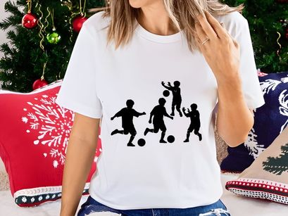 Four black silhouettes of boys playing soccer with balls