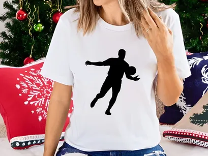 Silhouette of a man playing soccer or football with a ball