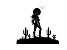 Silhouette of a cowboy standing on a desert hill