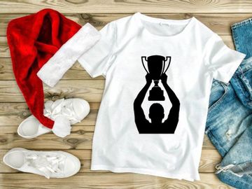 A person holding up a trophy in triumph and celebration preview picture