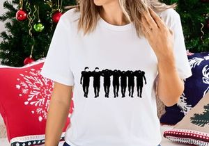 Seven people walking in a line with arms around each other's shoulders in black silhouette