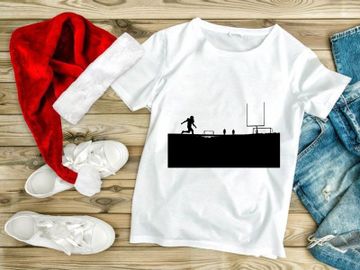 Silhouette of a person kicking a ball in a sports field at sunset preview picture