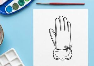 Handmade Christmas glove puppet with white yarn and bow for festive holiday crafts
