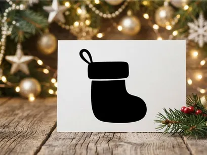 Black silhouette of a Christmas stocking isolated on a white background