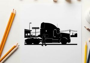 Silhouette of a man walking beside a large truck