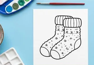 Hand-drawn white knitted Christmas stocking with snowflake patterns and cuff detail