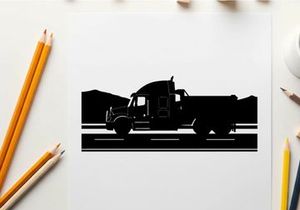 Silhouette of a large truck driving on a road with mountains