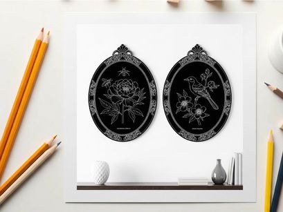 Silhouette artwork of two ornate oval frames on a shelf