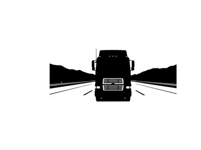 Silhouette of a semi truck driving down a highway with mountains