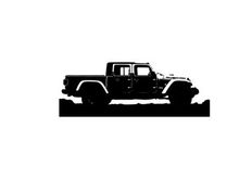 Silhouette of a jeep truck against a mountainous landscape silhouette