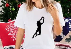 Silhouette of a person jumping to catch a ball
