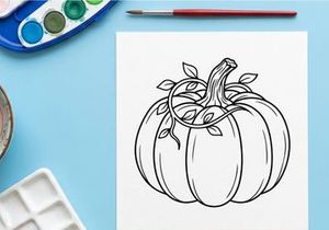 Pumpkin with vine and leaves for autumn harvest. Seasonal vegetable display for fall decor.