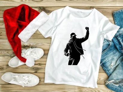 A person wearing a hoodie and cap with one arm raised in a gesture