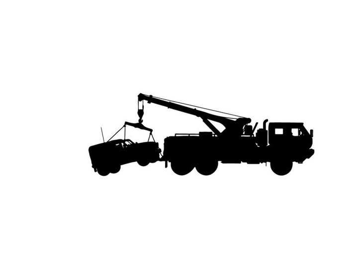 Silhouette of a tow truck with a boat on a trailer