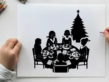 Family christmas dinner in silhouette with tree