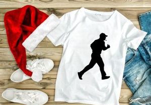 A silhouette of a man jogging or running in a casual outfit and cap