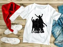 A group of people celebrating with one person lifted up in triumph