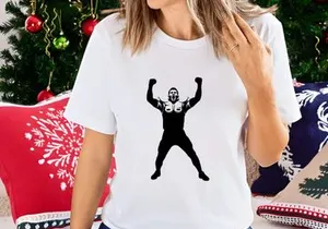 A football player celebrating a touchdown with arms raised in victory and excitement