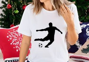 Soccer player kicking a ball in motion silhouette