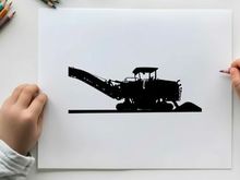 Silhouette of a large industrial machine with conveyor belt in operation