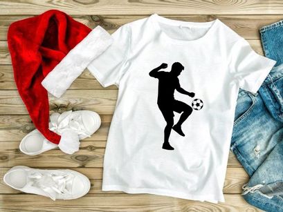 Silhouette of a soccer player kicking a ball with dynamic movement and energy