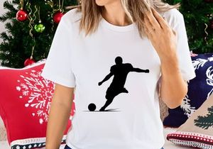 Soccer player kicking a ball in mid action silhouette