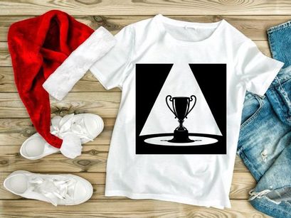 A shining trophy cup on a pedestal under a spotlight beam in darkness