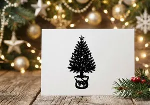 Black and white silhouette of a decorated Christmas tree in a burlap sack pot
