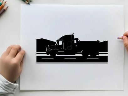 Silhouette of a large truck driving on a road with mountains