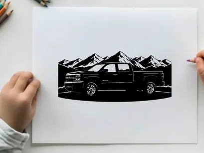 Silhouette of a pickup truck in front of mountains