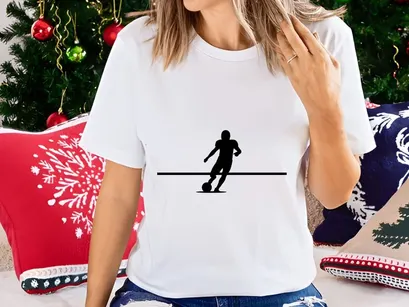 Silhouette of a soccer player kicking a ball in motion