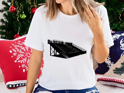 Black and white image of a large outdoor stadium seating structure with metal railings