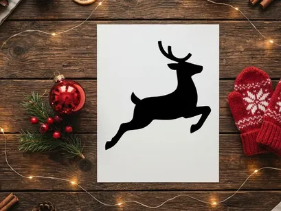 Black silhouette of a jumping reindeer isolated on a white background for Christmas design.