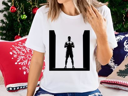 A silhouette of a man in a powerful stance with hands clasped together