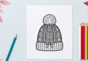 Hand-drawn winter knit hat with snowflake pattern and pom pom for festive holiday fashion