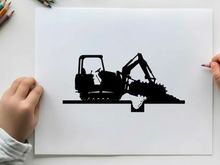 Silhouette of a black excavator digging into a pile of dirt