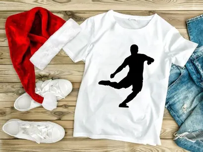 A silhouette of a person kicking an object with their right leg