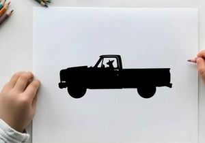 Silhouette of a pickup truck with a dog sticking out the window