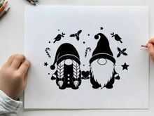 Black silhouette of two gnomes with birds and stars